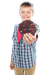 Image showing Sweet little boy offering you a chocolate cookie