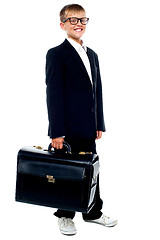 Image showing Full length portrait of cute boy carrying a briefcase