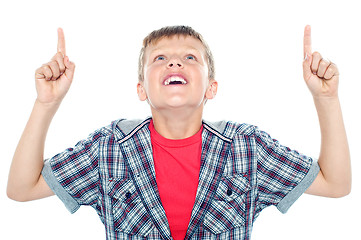 Image showing Smiling young child looking up and pointing