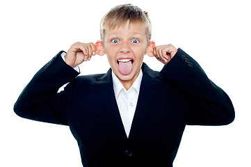 Image showing Notorious little boy making faces and teasing