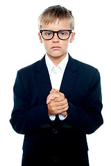 Image showing Pensive looking boy posing with hands clasped