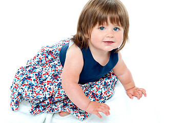Image showing Adorable 10 months old baby girl crawling