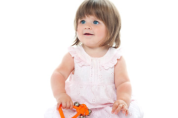 Image showing Adorable blonde infant playing with a rattle