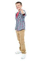 Image showing Smartly dressed young kid showing thumbs up gesture