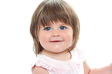 Image showing Closeup shot of a chubby female kid with blue eyes