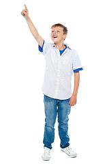 Image showing Charming young boy pointing towards copyspace area