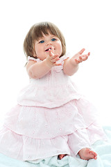 Image showing Adorable blonde baby asking for her toys