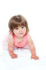 Image showing Isolated curious pretty girl child crawling