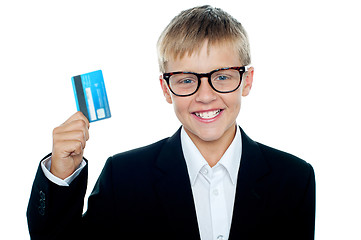 Image showing Young kid in business suit flaunting a debit card