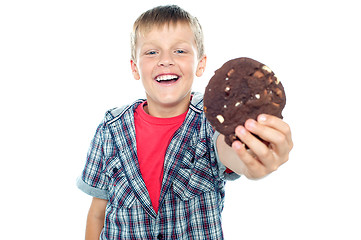 Image showing Cheerful boy offering you a chocolate cookie