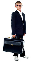 Image showing Serious young business boy holding office briefcase