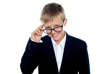 Image showing Young business boy looking through his glasses