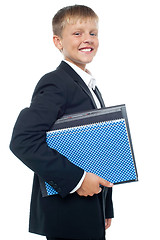 Image showing Cheerful little boy holding business files