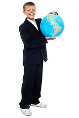 Image showing Smart looking young kid holding globe