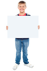 Image showing Full length portrait of boy holding blank whiteboard