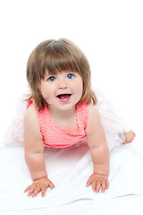 Image showing A cute little baby girl is staring up