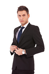 Image showing business man buttoning his coat 