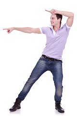 Image showing Casual young man pointing to blank space