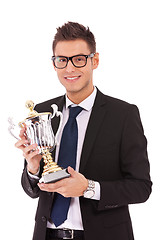 Image showing business man holding a trophy