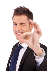 Image showing Business man winking with ok sign