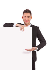 Image showing young business man showing  board