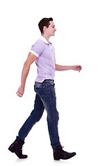 Image showing side view of a fashion man walking forward