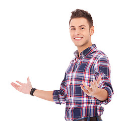 Image showing casual man in welcoming gesture