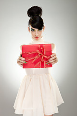 Image showing Young  woman holding gift