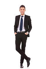 Image showing business man standing with hands in pocket 