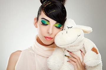 Image showing Fashion girl posing with teddy 