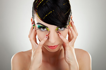 Image showing Woman face with color makeup and manicure