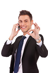 Image showing business man on the phone approving