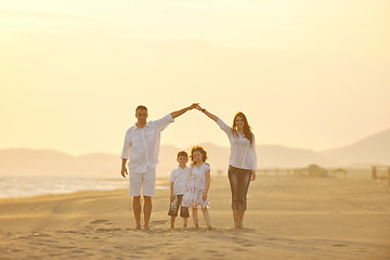 Image showing happy young family have fun on beach at sunset