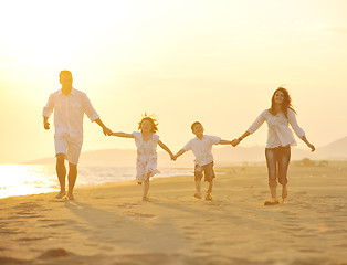 Image showing happy young family have fun on beach at sunset