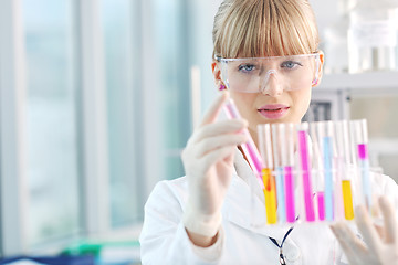 Image showing female researcher holding up a test tube in lab