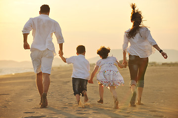 Image showing happy young family have fun on beach at sunset