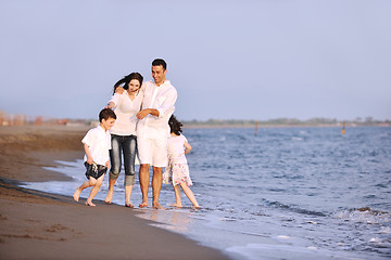 Image showing happy young family have fun on beach at sunset