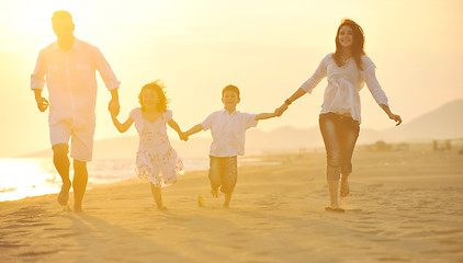 Image showing happy young family have fun on beach at sunset