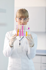 Image showing female researcher holding up a test tube in lab