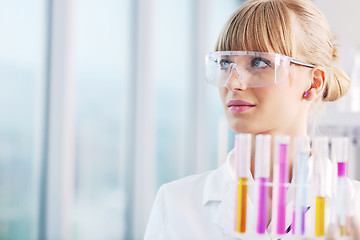 Image showing female researcher holding up a test tube in lab