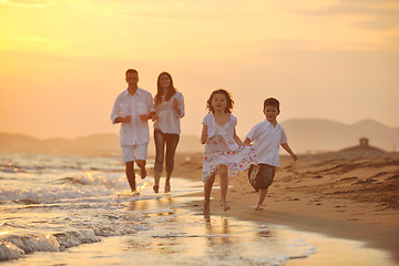 Image showing happy young family have fun on beach at sunset