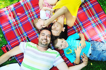 Image showing happy young couple with their children have fun at park