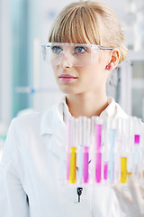 Image showing female researcher holding up a test tube in lab