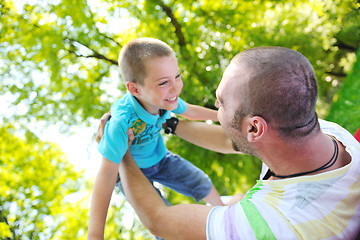 Image showing happy father and son have fun at park