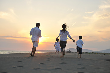 Image showing happy young family have fun on beach at sunset