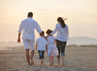 Image showing happy young family have fun on beach at sunset