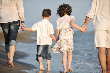 Image showing happy young family have fun on beach at sunset