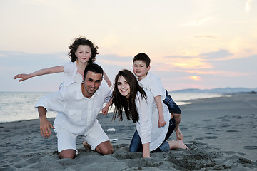 Image showing happy young family have fun on beach