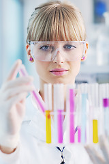 Image showing female researcher holding up a test tube in lab