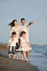 Image showing happy young family have fun on beach at sunset